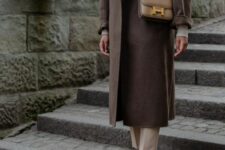 21 a neutral turtleneck, tan pants, tan loafers, a chocolate brown midi coat and a beige crossbody bag