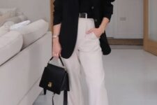 22 a dramatic look with a black t-shirt and an oversized blazer, neutral trousers, white sneakers and a black bag is great for spring