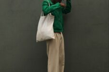 22 a green zip shirt, beige trousers, white sneakers, a beige bucket hat and a neutral canvas bag for spring