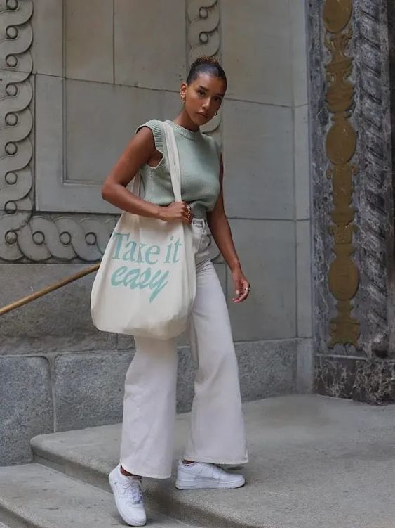 a light green jersey sleeveless top, neutral flare jeans, white sneakers, a neutral canvas bag are a cool idea for spring