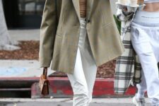 23 a tan top, white pants, tan shoes, an olive green oversized blazer and a brown mini bag for spring or summer