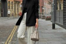 24 a minimalist work look with a black t-shirt and a blazer, white trousers, grey loafers, a grey bag is super cool