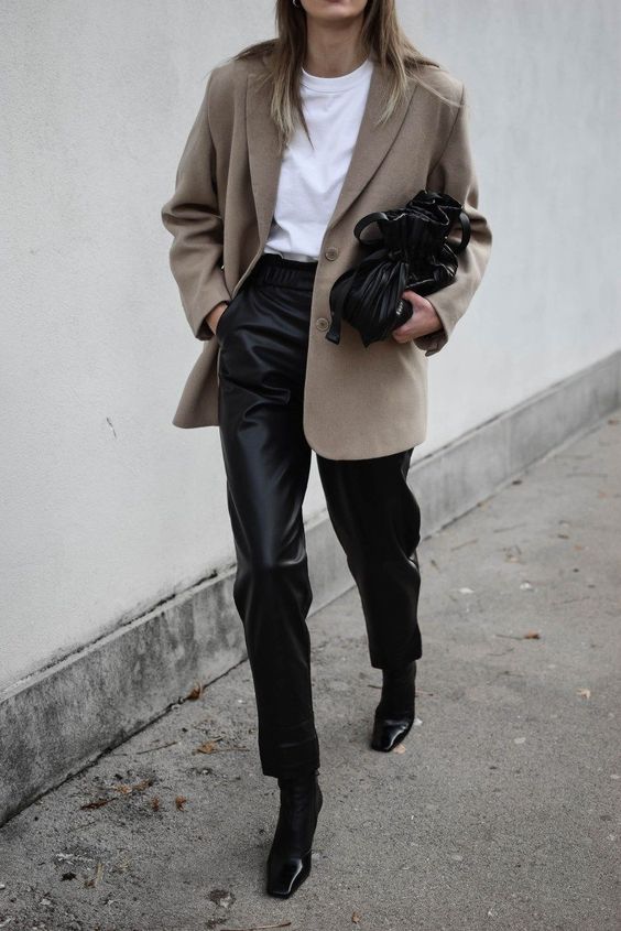 a white t-shirt, black leather pants, black boots, a greige oversized blazer and a black bag are a simple spring work look