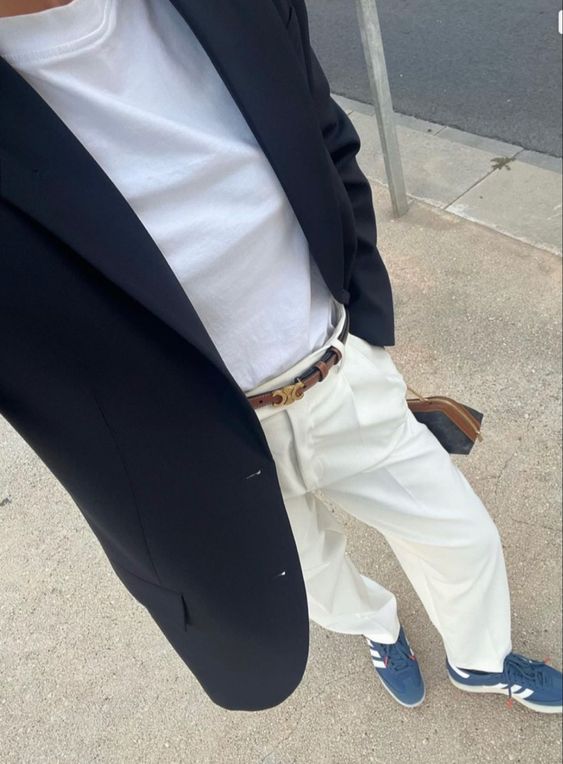 a white t shirt, creamy pants, a navy oversized blazer, blue sneakers and a small bag for an elegant look