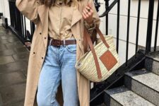 25 a beige shirt, a beige trench, blue jeans, a brown belt, brown loafers and a straw bag are a cool look for spring