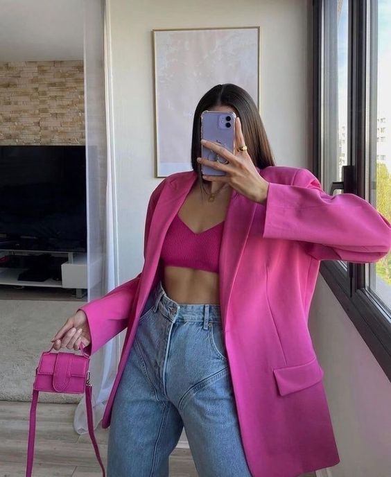 a hot pink bra and an oversized blazer, a mini bag and blue jeans are a sexy and bold look for spring