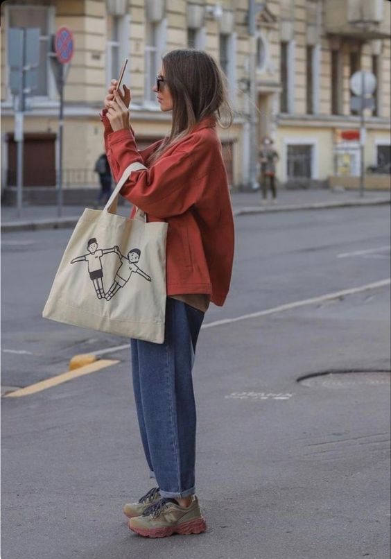 a red jacket, blue jeans, grey trainers, a neutral canvas bag are a great look for spring or fall