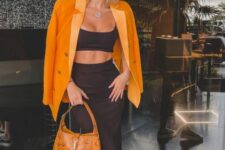 29 a black bra and midi skirt, black and white sneakers, an orange blazer and an orange bag for a sexy summer look