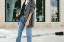 29 a black top, blue jeans with a raw hem, a plaid oversized blazer, black and creamy shoes