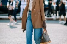 30 a bold and cool look with a white shirt, blue jeans, black boots, a camel oversized blazer, a printed bag and a black wide-brim hat