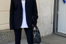30 a sport chic monochromatic look with a white tee, black leggings and a black oversized blazer, white socks and trainers, a black bag
