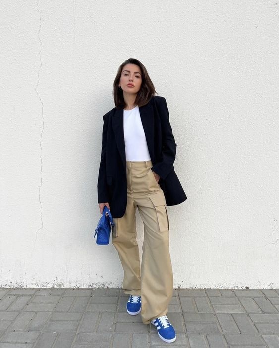 beige cargo pants, a white t shirt, an oversized black blazer, electric blue Gazelle sneakers and a matching bag