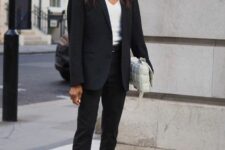 31 black jeans, a white top, an oversized black blazer, black sneakers and a white woven bag are a nice look for work
