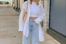 32 a white top top, an oversized white shirt, bleached high waisted jeans, white sneakers and a beige bag with chain for spring