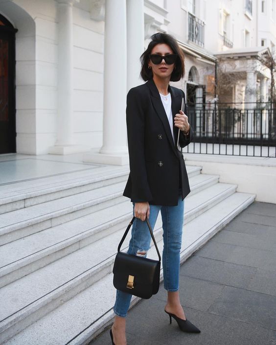 a stylish work outfit with a white t-shirt, blue cropped jeans, black heeled shoes, a black crossbody bag