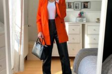 33 a white crop top, black leahter pants, white trainers, an orange blazer and a black bag are a great combo