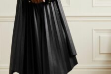 34 a tan long sleeve top, a black leather pleated midi skirt, black shoes and a modern black clutch