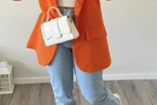 34 a white crop top, trainers and a bag, blue jeans, an orange blazer are a gerat combo for spring and fall
