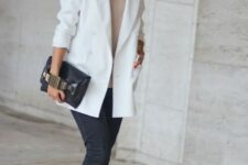 38 a neutral top, black straight jeans, white boots, a white oversized blazer and a black bag