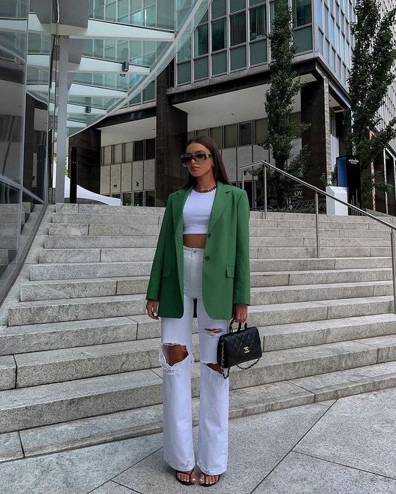 a white crop top, white ripped jeans, a green oversized blazer, black bag, black heels are great for summer