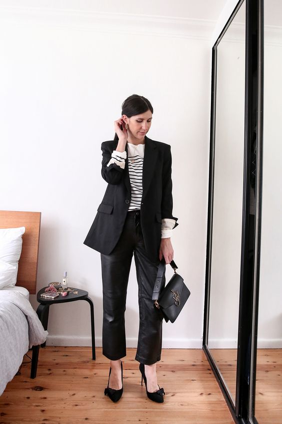 an elegant work outfit with a Breton strip top, black leather pants, black bow shoes, a black blazer and a cool bag
