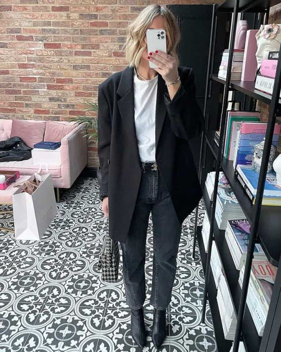 a white t-shirt, grey cropped jeans, black pointed toe boots, an oversized black blazer and a printed bag for a cool monochromatic look
