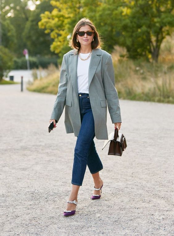 a white t-shirt, navy cropped jeans, an oversized sage blazer, purple emmbellished shoes and a brown bag plus a chain necklace