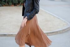 With beige shirt and black and brown leather high heeled ankle boots