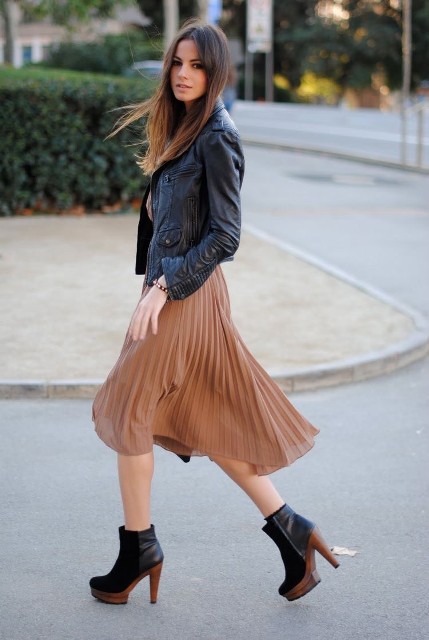 With beige shirt and black and brown leather high heeled ankle boots