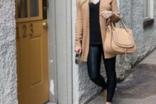With black shirt, beige leather bag, beige suede flat shoes and golden earrings