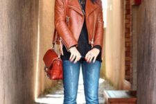 With black shirt, brown leather bag and black leather boots