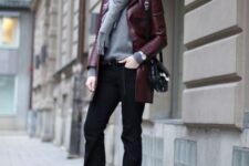 With gray sweater, gray scarf with a fringe, black leather bag and black boots