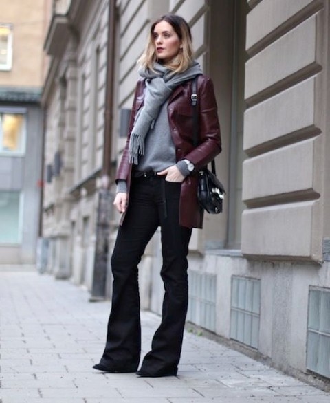 With gray sweater, gray scarf with a fringe, black leather bag and black boots
