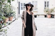 With gray wide brim hat, sunglasses, black loose top, black leather bag and black and gray leopard printed flat shoes