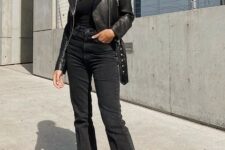 With oversized sunglasses, black one shoulder fitted top and black leather boots