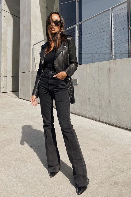 With oversized sunglasses, black one shoulder fitted top and black leather boots