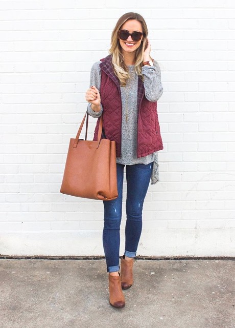 With oversized sunglasses, gray ruffled shirt, brown leather tote bag and brown suede ankle boots