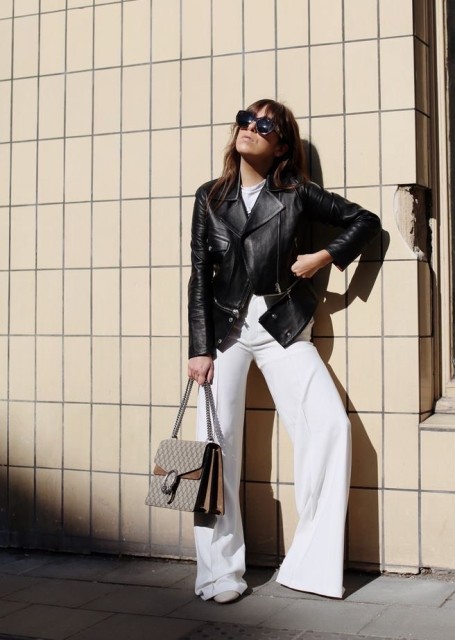 With oversized sunglasses, white shirt, gray printed chain strap bag and beige shoes