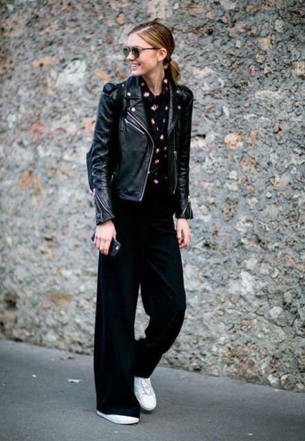 With rounded sunglasses, black, white and pink printed shirt, black leather bag and white lace up flat shoes