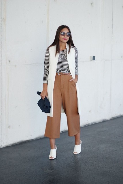 With sunglasses, black and white striped shirt, white leather cutout mules and dark blue clutch