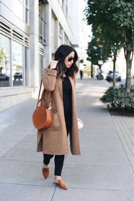 With sunglasses, black shirt, brown leather rounded bag and brown suede flat mules