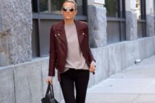 With sunglasses, pale pink loose t-shirt, black leather ankle boots and black leather bag