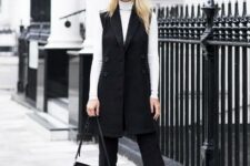 With sunglasses, white fitted turtleneck, black leather and suede bag and black leather mid calf boots