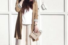 With white loose shirt, beige leather clutch and high heeled shoes