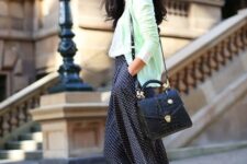 With white shirt, black leather bag and golden pumps