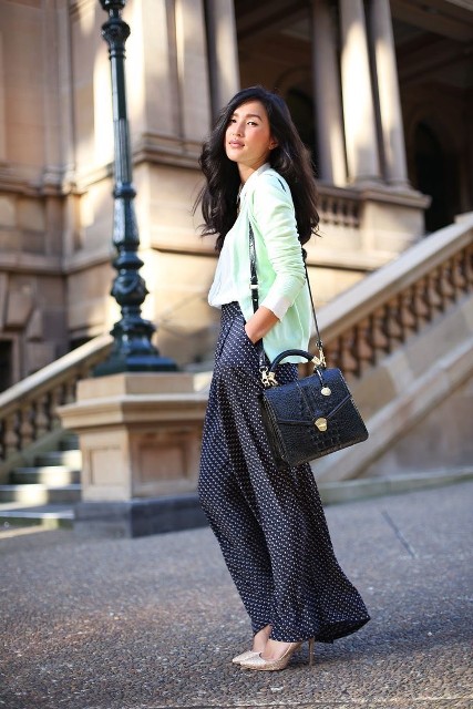 With white shirt, black leather bag and golden pumps