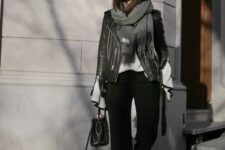 With white shirt, gray fringe scarf, sunglasses, black leather mini bag and black leather boots