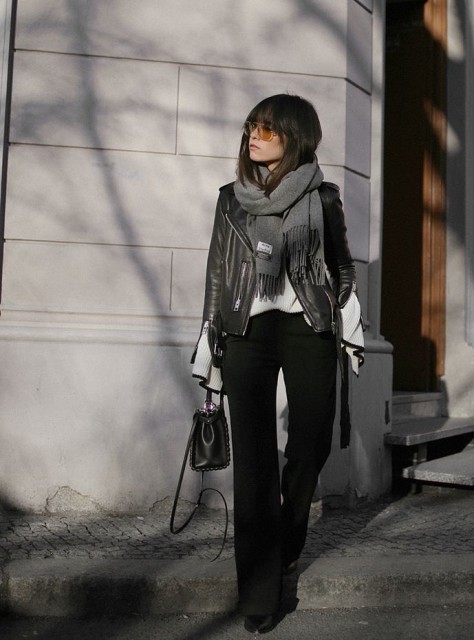 With white shirt, gray fringe scarf, sunglasses, black leather mini bag and black leather boots