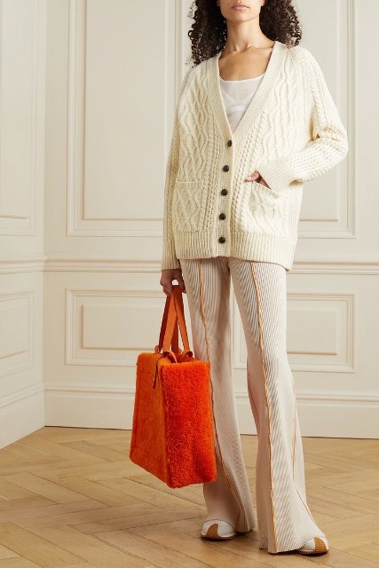 With white shirt, white and brown sneakers and orange tote bag
