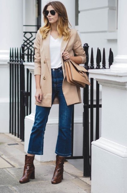 With white top, sunglasses, beige leather and suede bag and brown leather mid calf boots